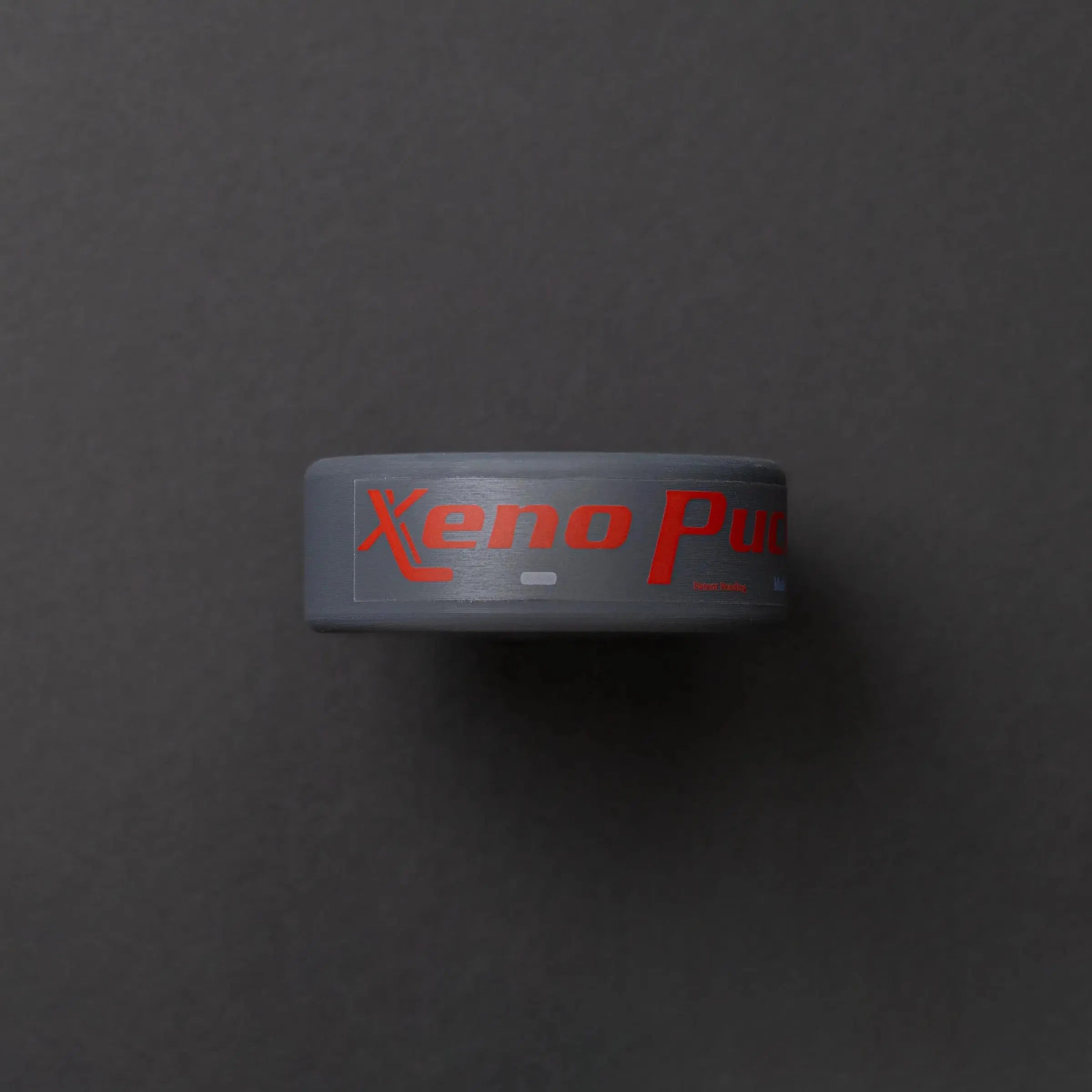 Xenopuck against a dark background